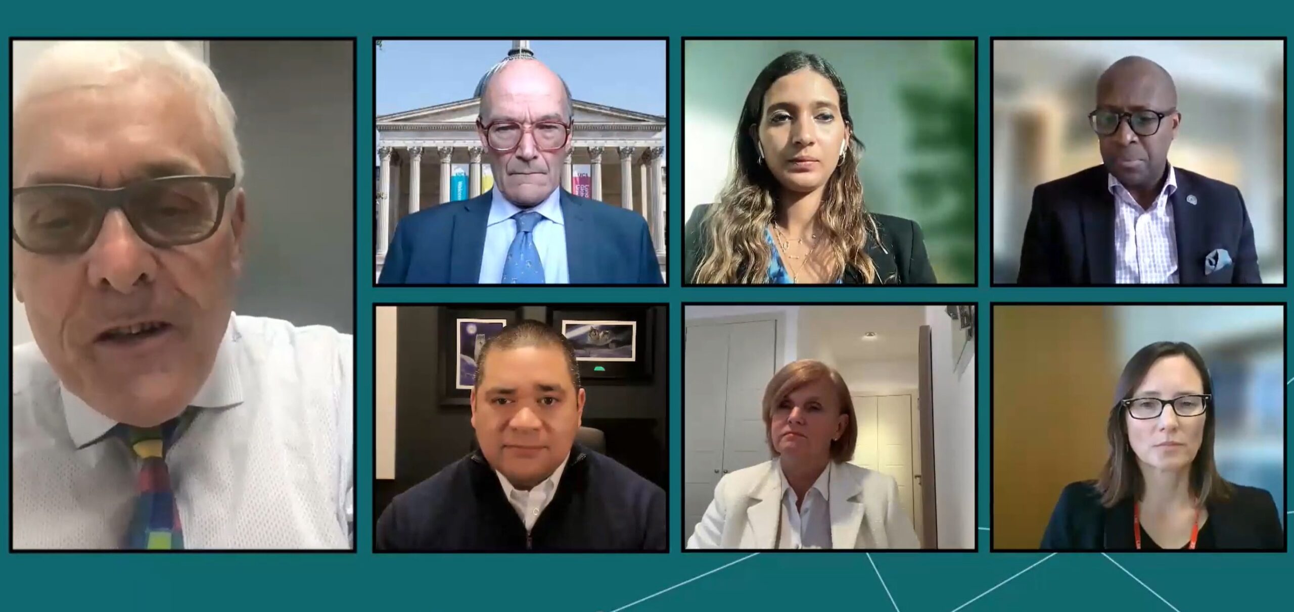 Screenshot of a virtual meeting with eight participants displayed in a grid layout, each in different indoor settings.