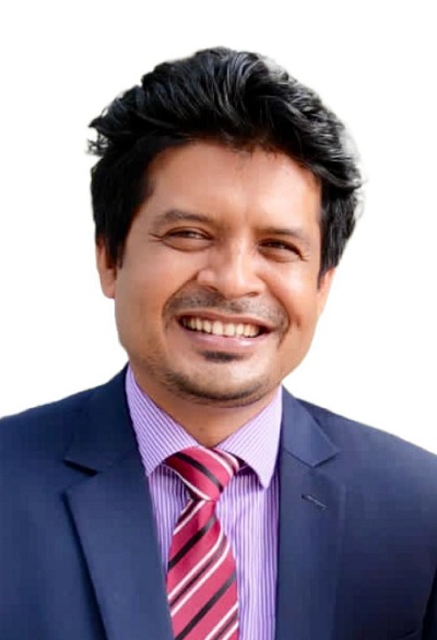 Headshot of Abdullah smiling in a blue suit